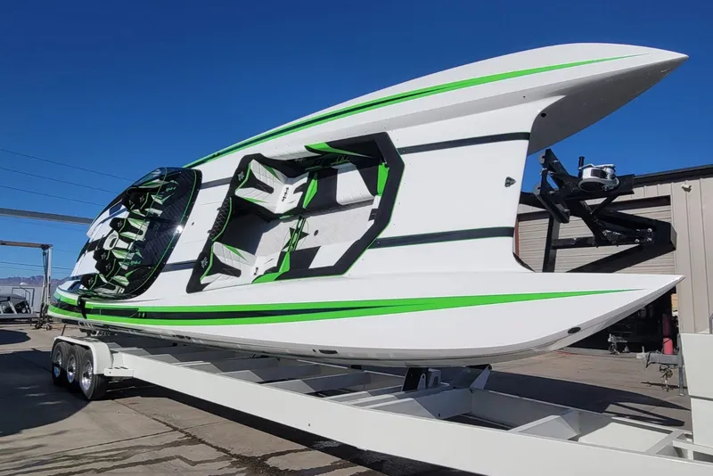 Slide: The Image of 2022 Daves Custom Boats DCB M-44 with green accents on a trailer. - 5