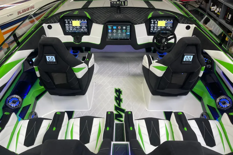 Slide: The Image of 2022 Daves Custom Boats DCB M-44 cockpit with modern controls and green accents. - 27