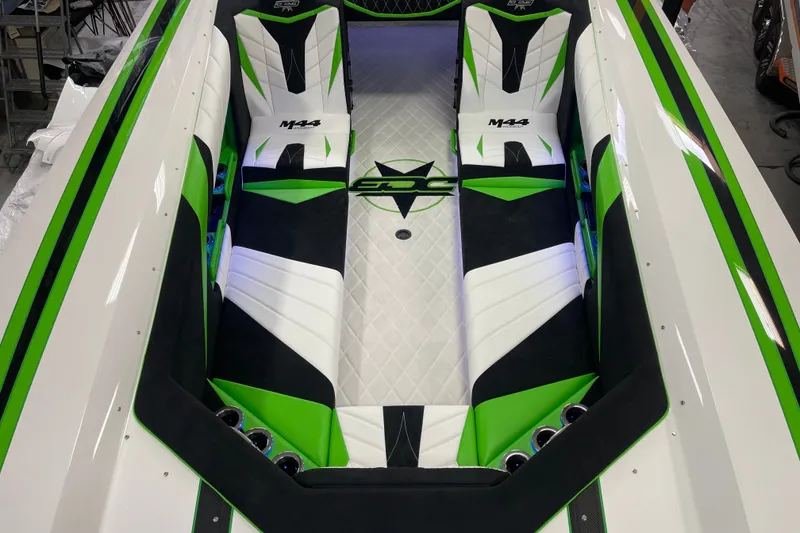 Slide: The Image of 2022 Daves Custom Boats M-44 interior with green, black, and white seating design. - 15