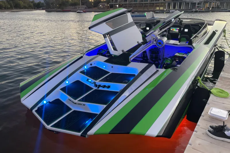 Slide: The Image of 2022 Daves Custom Boats DCB M-44 with vibrant lights docked at sunset. - 11