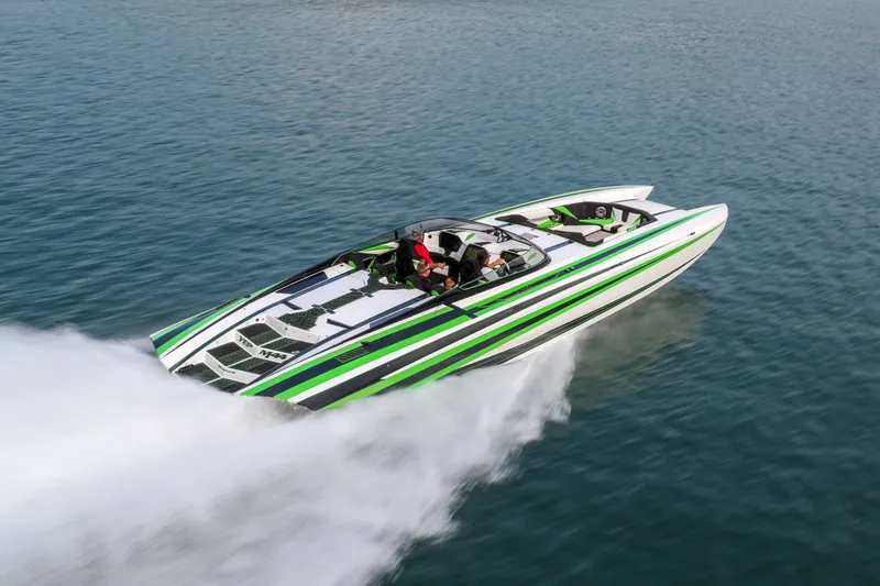 Slide: The Image of 2022 Daves Custom Boats M-44 speeding on water, featuring sleek green and white design. - 40