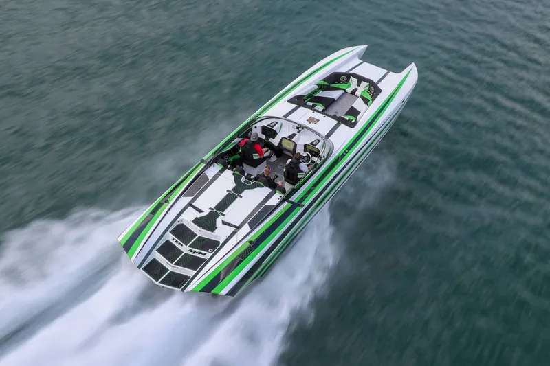 Slide: The Image of 2022 Daves Custom Boats M-44 speeding on water, featuring sleek green and white design. - 39