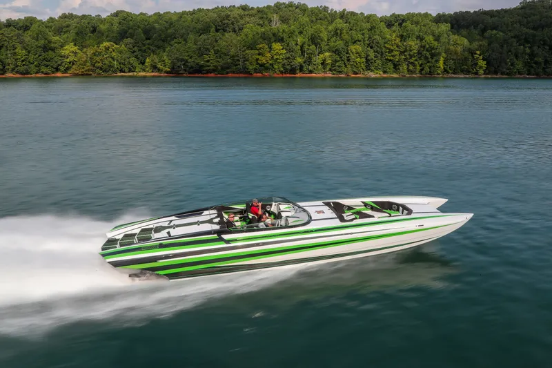 Slide: The Image of 2022 Daves Custom Boats M-44 speeding on a lake with lush forest backdrop. - 41
