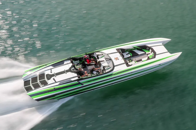 Slide: The Image of 2022 Daves Custom Boats M-44 speeding on water, featuring sleek green and white design. - 1
