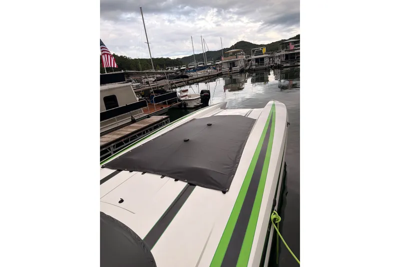 Slide: The Image of 2022 Daves Custom Boats M-44 docked, featuring sleek green and black design. - 10