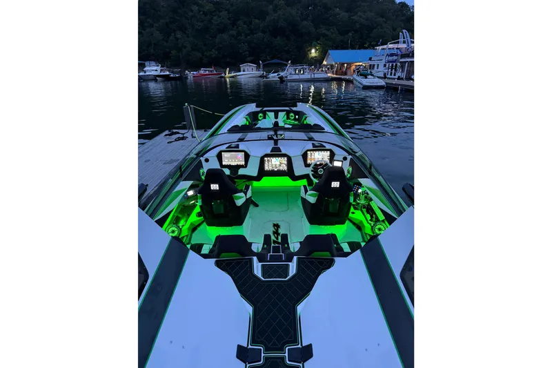 Slide: The Image of 2022 Daves Custom Boats M-44 with illuminated cockpit, docked at a serene lakeside marina. - 12