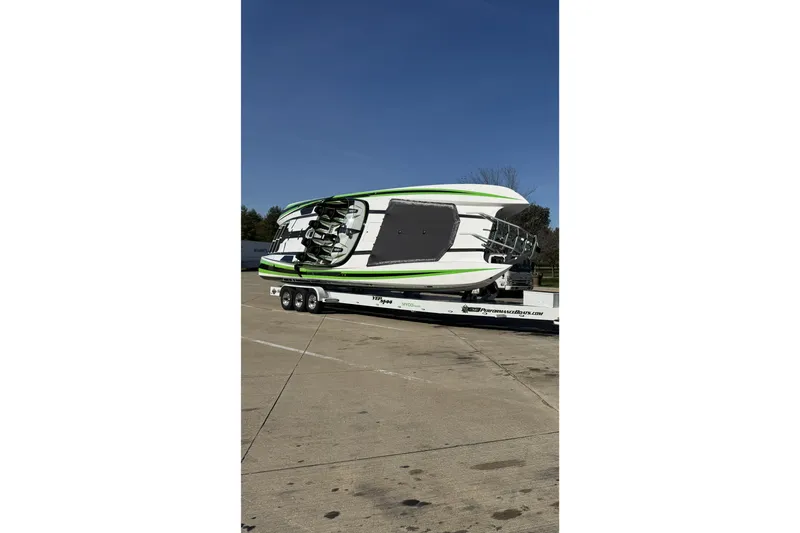 Slide: The Image of 2022 Daves Custom Boats M-44 on trailer, parked in a lot under clear blue sky. - 8