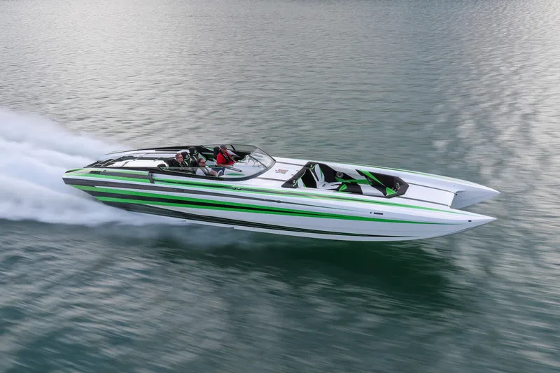 Slide: The Image of 2022 Daves Custom Boats M-44 speeding on water, featuring sleek green and white design. - 38