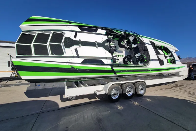 Slide: The Image of 2022 Daves Custom Boats DCB M-44 on trailer, featuring sleek green and black design. - 3