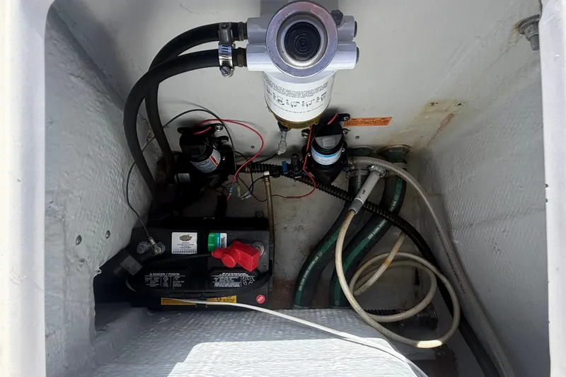 Slide: The Image of 2002 Grady-White Fisherman 222 boat compartment with battery and wiring setup. - 18