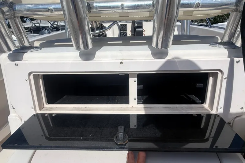 Slide: The Image of Storage compartment on a 2002 Grady-White Fisherman 222 boat, featuring rod holders. - 25