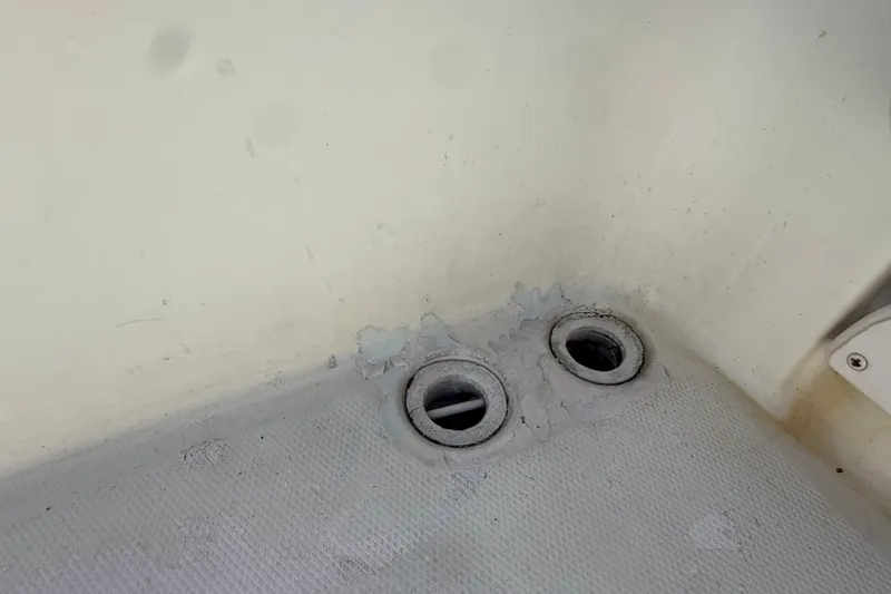 Slide: The Image of 2002 Grady-White Fisherman 222 boat deck with dual drainage holes. - 21