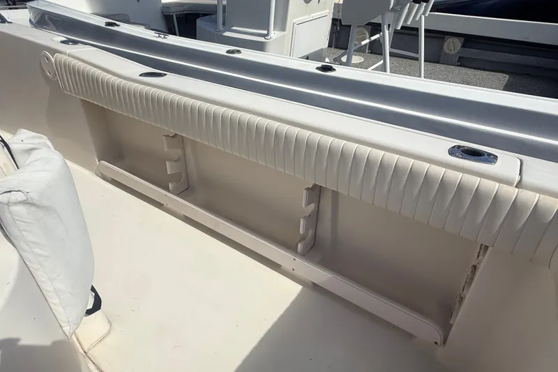 Slide: The Image of Interior view of a 2002 Grady-White Fisherman 222 boat, featuring seating and rod holders. - 23