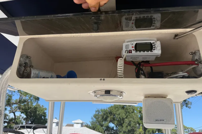 Slide: The Image of Storage compartment on a 2002 Grady-White Fisherman 222 boat with radio equipment. - 28