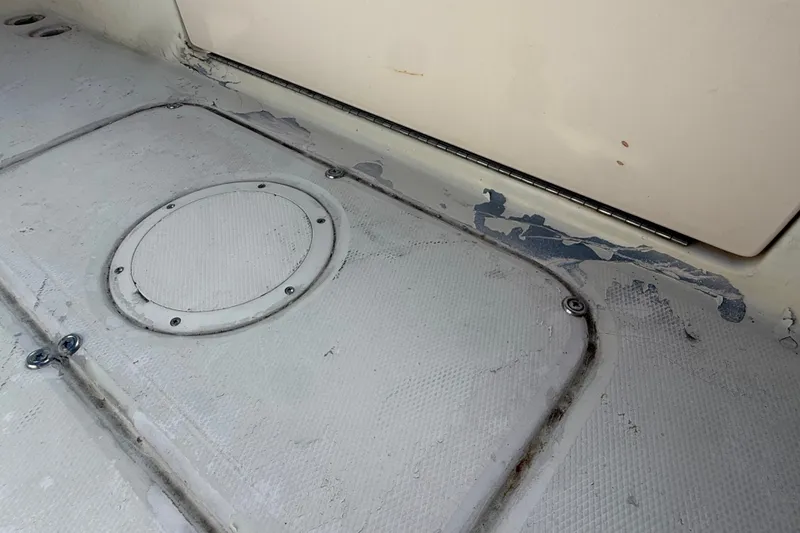 Slide: The Image of Worn deck of 2002 Grady-White Fisherman 222 boat showing peeling paint and hatch cover. - 20