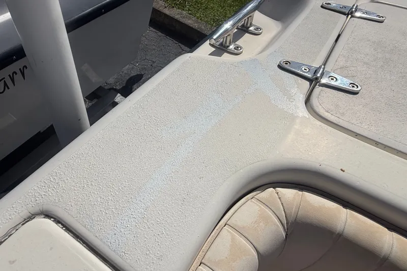 Slide: The Image of 2002 Grady-White Fisherman 222 boat deck with textured surface and metal hinges. - 15