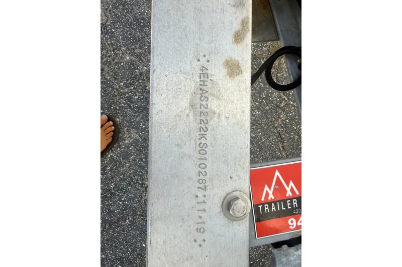 Slide: The Image of VIN on Grady-White Fisherman 222 boat trailer, 2002 model, with foot visible. - 41