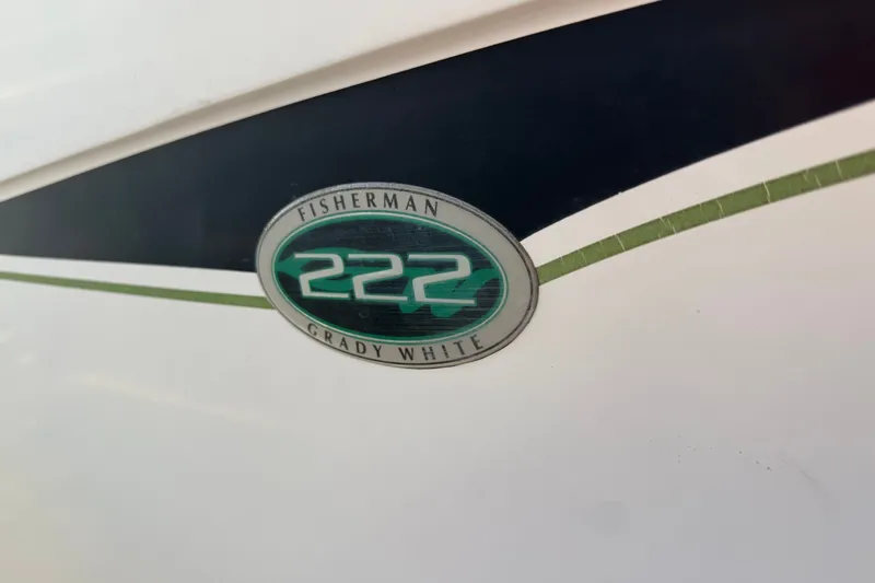 Slide: The Image of Grady-White Fisherman 222 boat emblem, 2002 model, featuring sleek design elements. - 8
