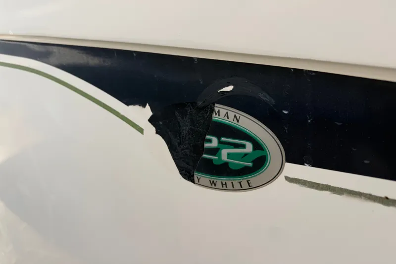 Slide: The Image of Damaged Grady-White Fisherman 222 boat emblem, 2002 model, with peeling paint. - 9