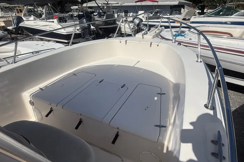 Slide: The Image of 2002 Grady-White Fisherman 222 boat deck with storage compartments, docked among other boats. - 32