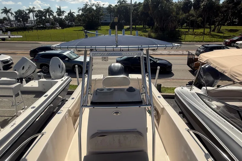 Slide: The Image of 2002 Grady-White Fisherman 222 boat with T-top, parked near road and other boats. - 34