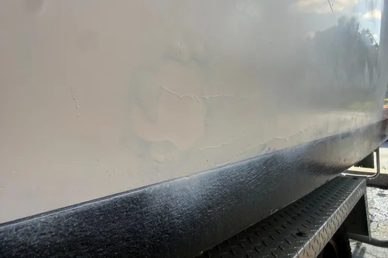 Slide: The Image of Close-up of 2002 Grady-White Fisherman 222 boat hull with visible wear and texture. - 11