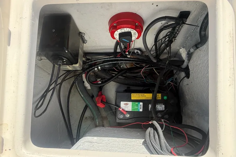 Slide: The Image of Electrical compartment of a 2002 Grady-White Fisherman 222 boat, showing battery and wiring. - 17