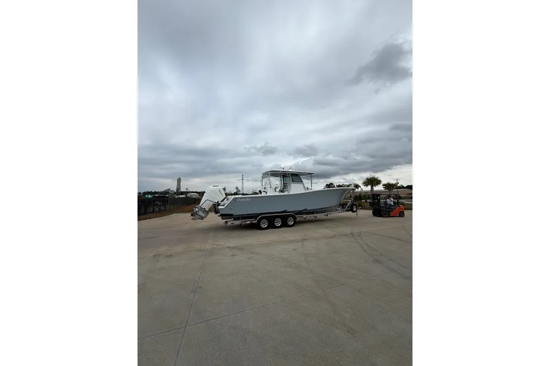 Slide: The Image of 2026 Onslow Bay 37 Tournament Edition boat on trailer under cloudy sky. - 98
