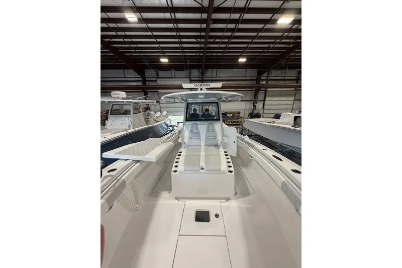 Slide: The Image of 2026 Onslow Bay 37 Tournament Edition boat in a showroom, showcasing sleek design. - 73