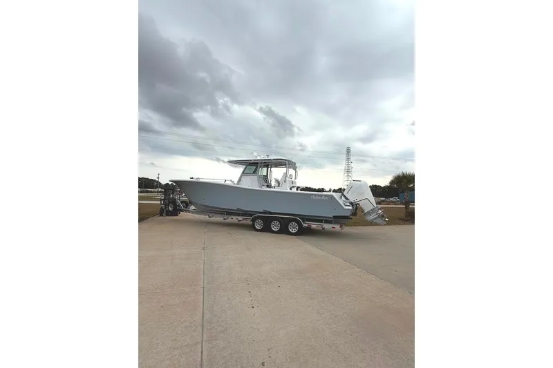 Slide: The Image of 2026 Onslow Bay 37 Tournament Edition boat on trailer under cloudy sky. - 104