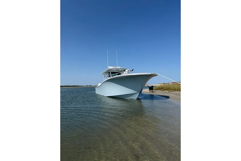 Slide: The Image of 2026 Onslow Bay 37 Tournament Edition boat anchored on a sandy shore. - 36