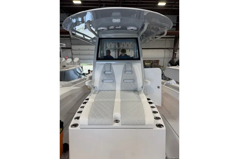 Slide: The Image of 2026 Onslow Bay 37 Tournament Edition boat interior with cushioned seating and rod holders. - 76