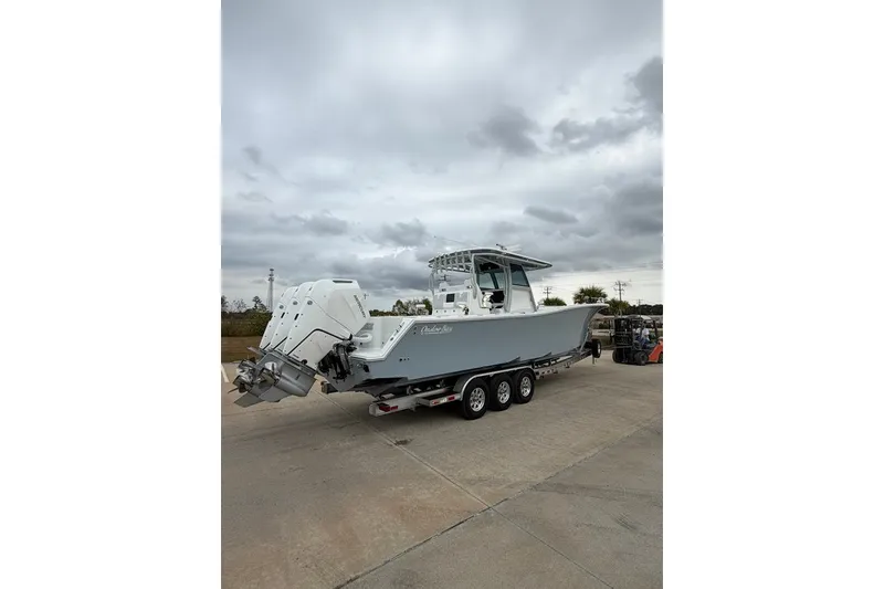 Slide: The Image of 2026 Onslow Bay 37 Tournament Edition boat on trailer under cloudy sky. - 100