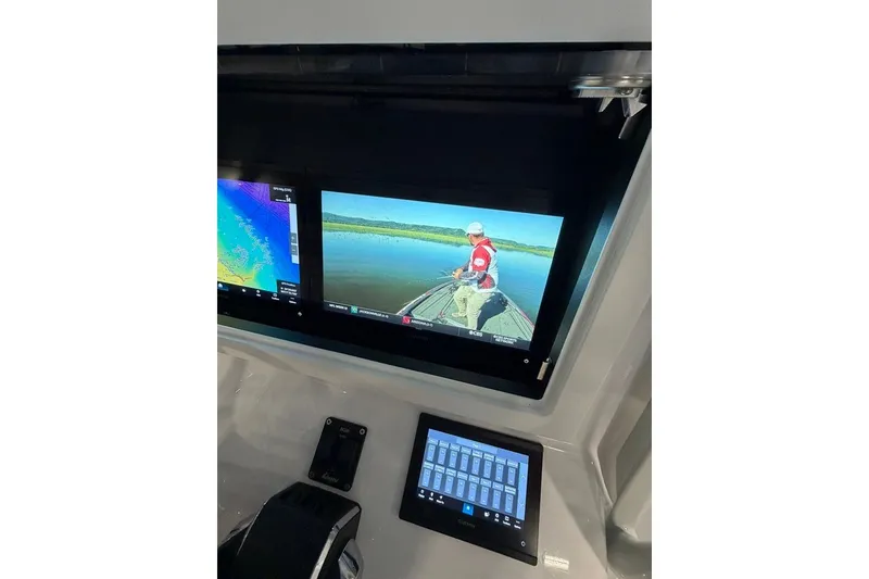 Slide: The Image of 2026 Onslow Bay 37 Tournament Edition boat dashboard with dual display screens. - 92