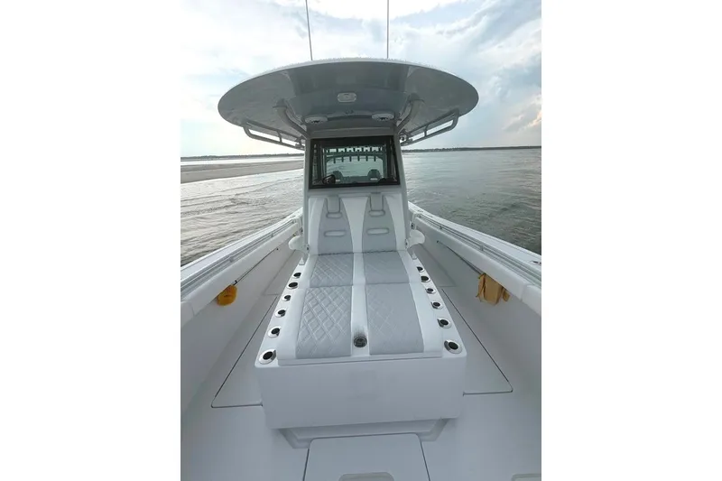 Slide: The Image of 2026 Onslow Bay 37 Tournament Edition boat interior with cushioned seating and ocean view. - 54