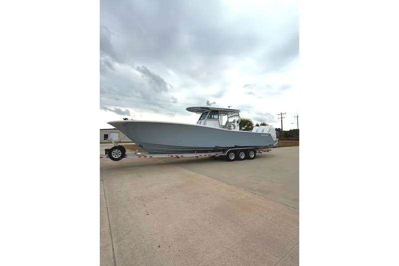 Slide: The Image of 2026 Onslow Bay 37 Tournament Edition boat on trailer under cloudy sky. - 106