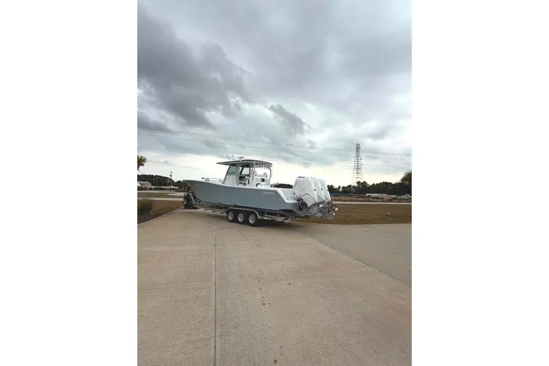 Slide: The Image of 2026 Onslow Bay 37 Tournament Edition boat on trailer under cloudy sky. - 103