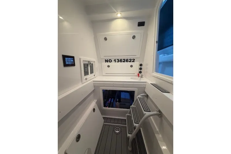 Slide: The Image of Interior of 2026 Onslow Bay 37 Tournament Edition boat, featuring control panels and storage. - 24