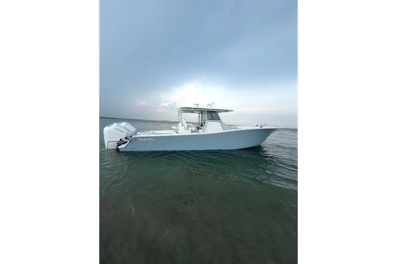 Slide: The Image of 2026 Onslow Bay 37 Tournament Edition boat on calm water under cloudy sky. - 49