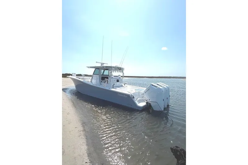 Slide: The Image of 2026 Onslow Bay 37 Tournament Edition boat docked on a sunny shoreline. - 34