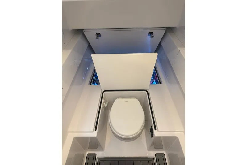 Slide: The Image of Onslow Bay 37 Tournament Edition 2026 boat interior with a compact marine toilet. - 23
