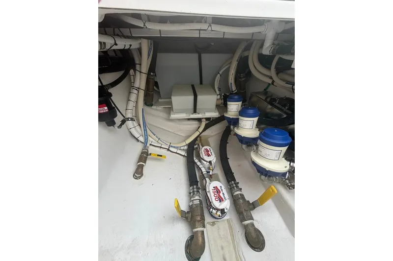 Slide: The Image of Engine compartment of 2026 Onslow Bay 37 Tournament Edition boat with visible hoses and filters. - 70