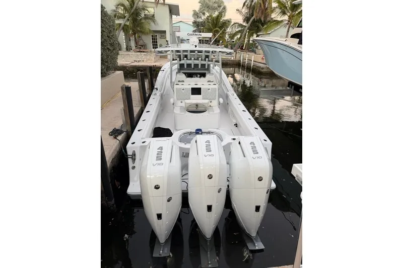 Slide: The Image of 2026 Onslow Bay 37 Tournament Edition boat docked with triple engines. - 123