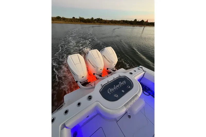 Slide: The Image of 2026 Onslow Bay 37 Tournament Edition boat with triple Mercury engines on water. - 119