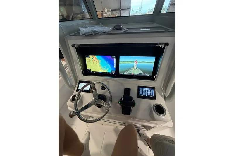 Slide: The Image of 2026 Onslow Bay 37 Tournament Edition boat dashboard with dual navigation screens and steering wheel. - 91