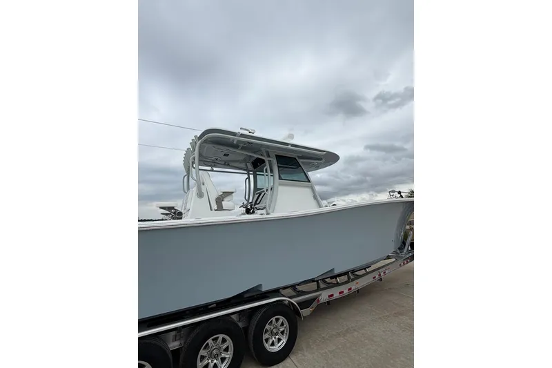 Slide: The Image of 2026 Onslow Bay 37 Tournament Edition boat on trailer under cloudy sky. - 101