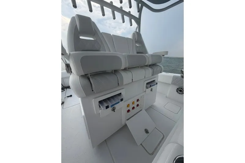 Slide: The Image of 2026 Onslow Bay 37 Tournament Edition boat seating with storage compartments and ocean backdrop. - 61