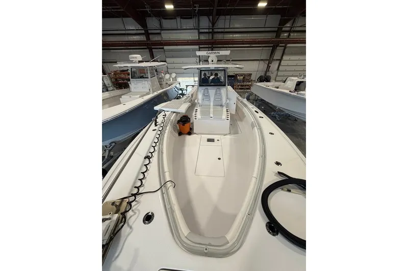 Slide: The Image of 2026 Onslow Bay 37 Tournament Edition boat in a showroom, featuring advanced navigation equipment. - 75