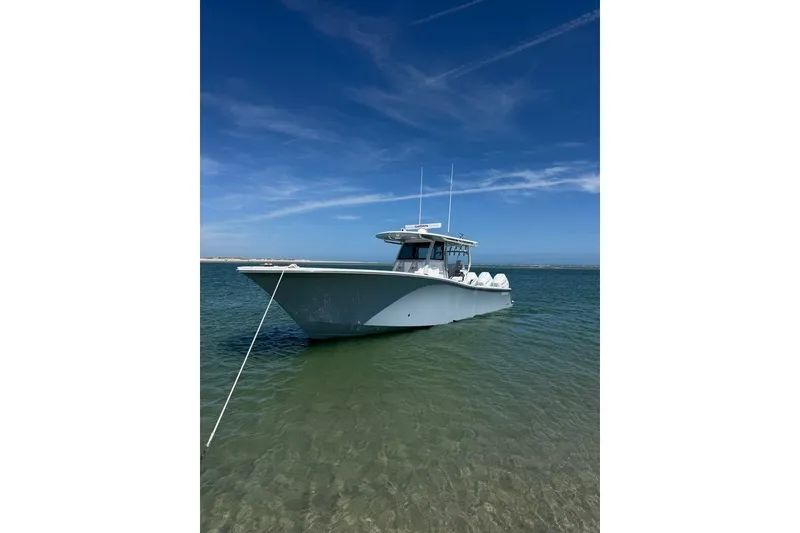 Slide: The Image of 2026 Onslow Bay 37 Tournament Edition boat anchored in clear water under blue sky. - 40