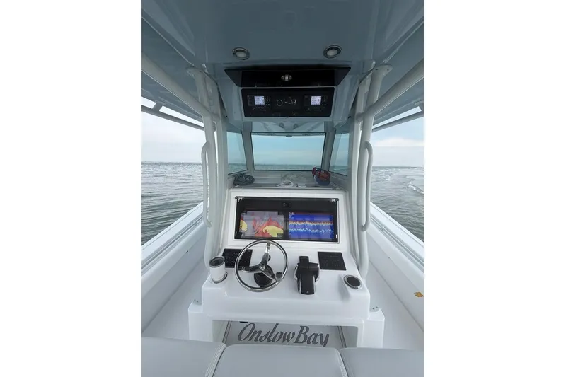 Slide: The Image of Interior view of 2026 Onslow Bay 37 Tournament Edition boat cockpit with navigation equipment. - 43
